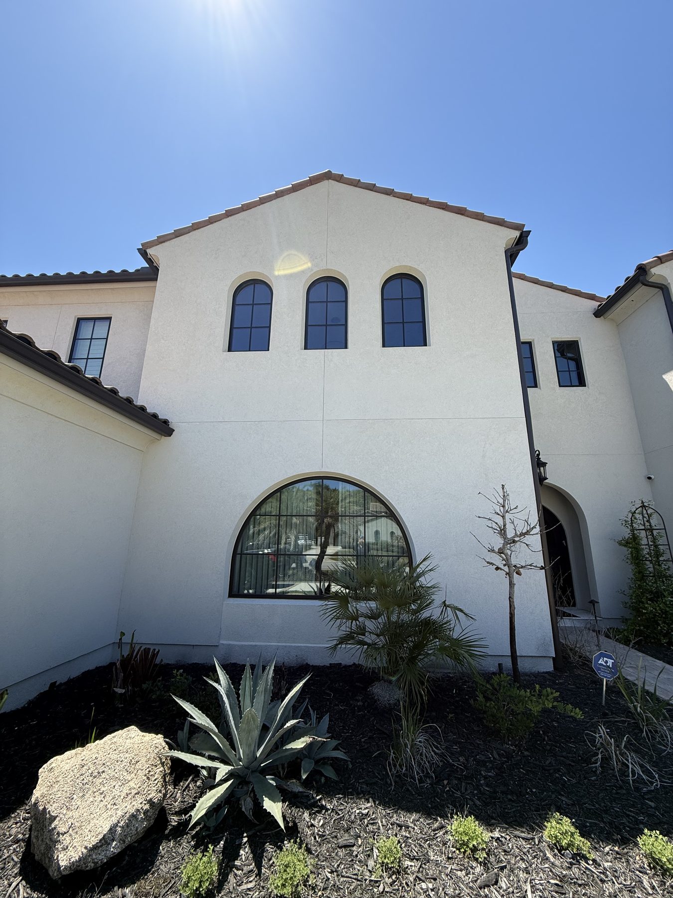 Two-story foyer window and Mediterranean facade